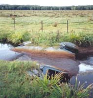 Figure 4. A weir used to contain acid groundwater Figure 4. A weir used to contain acid groundwater