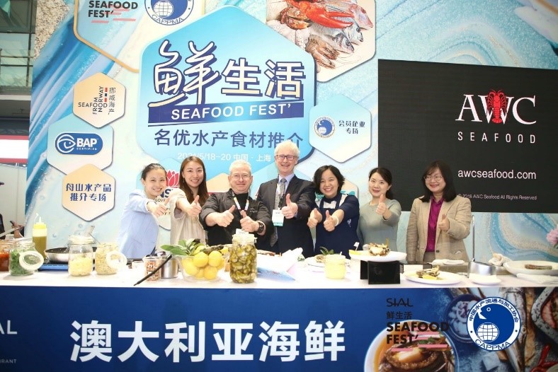 Representatives pose in a trade booth
