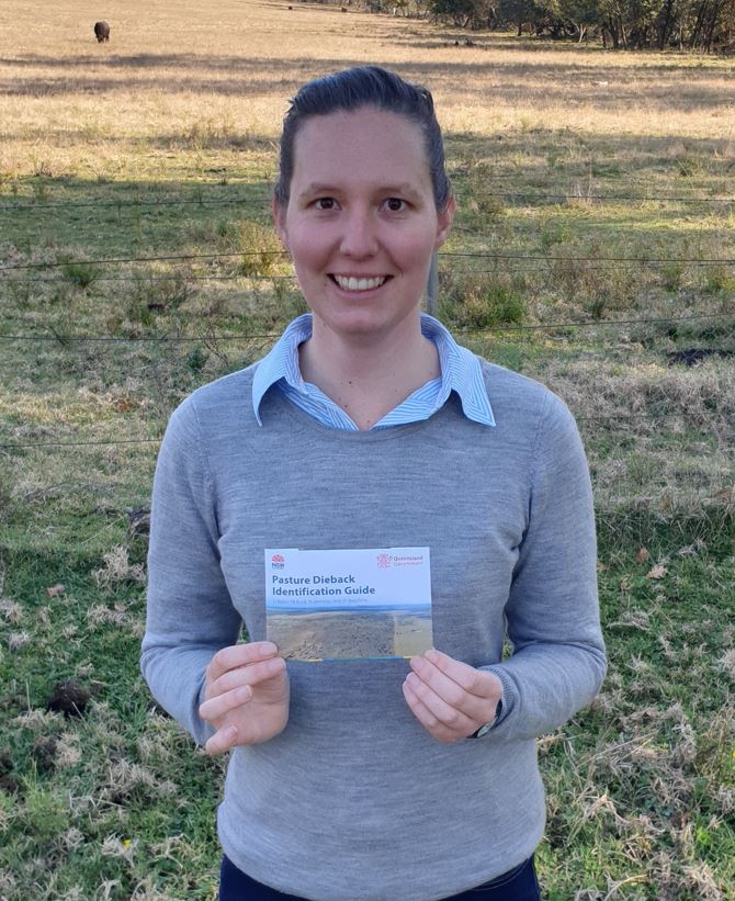 Woman holding a Pasture Dieback Identification Guide